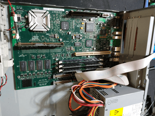 The power supply being installed next to the motherboard