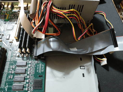 Two IDE cables being plugged into the motherboard.