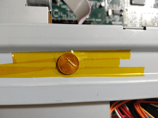 A one-cent piece taped to the cross-brace.