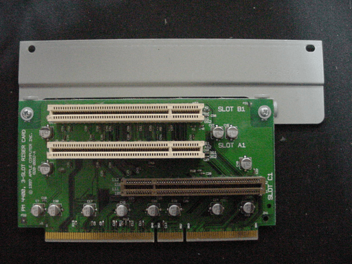 A riser-card with three edge-connectors on the front and golden contact-fingers on the bottom of the pcb.