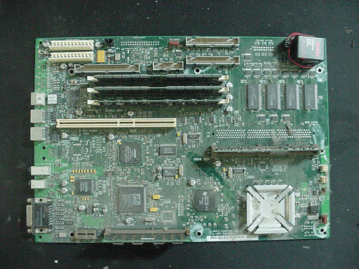 A very dusty computer motherboard on a desk.