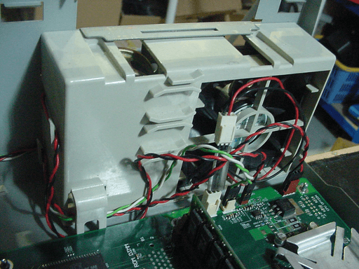 Multiple cables with small connectors plugged into the motherboard next to the front fan.