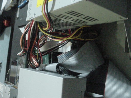 the cramped space between the cd drive and the power supply where a bunch of cables are stuffed.