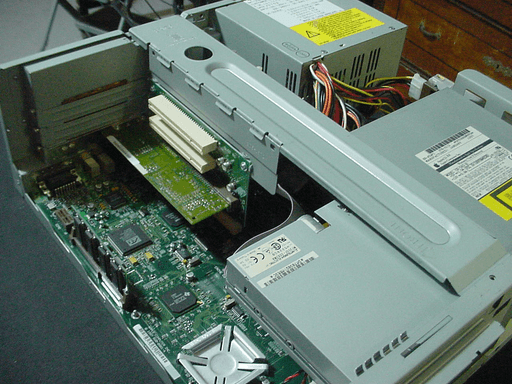 The cross-brace installed ontop of the case, holding the riser-card.