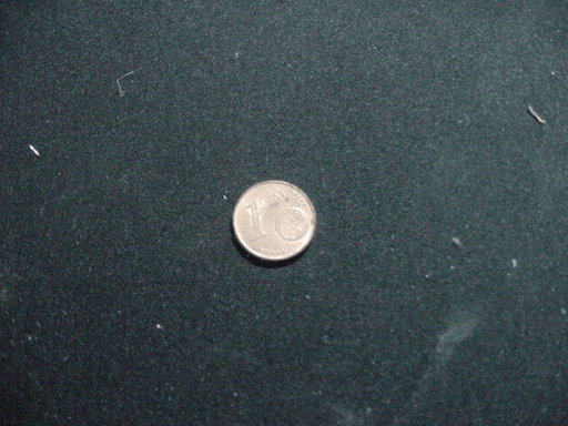 A one-cent pice on a desk.