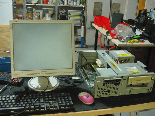 A photo of the computer next to a monitor showing a gray screen.