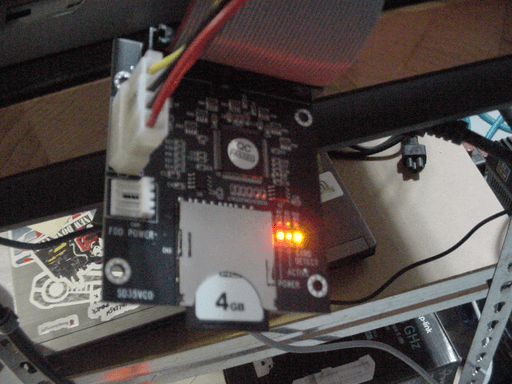 Photo of an sd to ide adapter with the status lights illuminated.