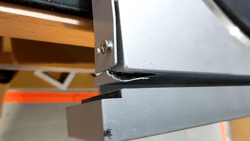 A top-down photo of the broken-off piece of plastic right behind the front panel.