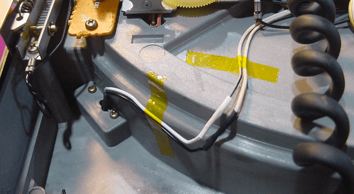 a photo of the wires from the last picture after they've been soldered together and taped down with tape.