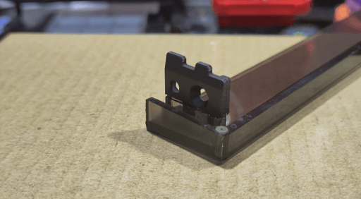 A photo of the replacement part being glued in place from one angle.